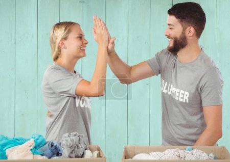 Photo for "Couple volunteers high five" - Royalty Free Image