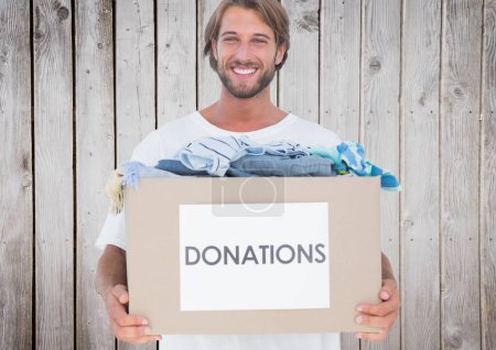 Photo for Digital composite of volunteer holding donation box - Royalty Free Image