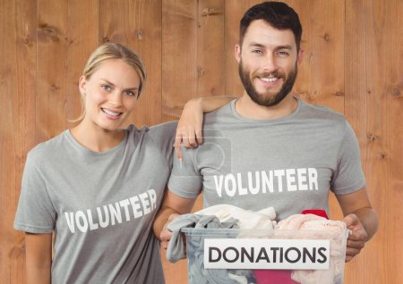 Photo for Digital composite of volunteers carrying donation box - Royalty Free Image