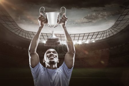 Photo for Composite image 3D of happy sportsman looking up while holding trophy - Royalty Free Image