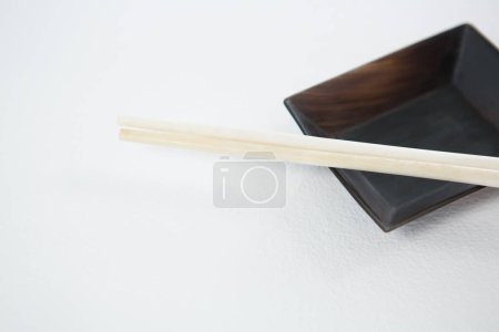Photo for Chopsticks with bowl on table - Royalty Free Image