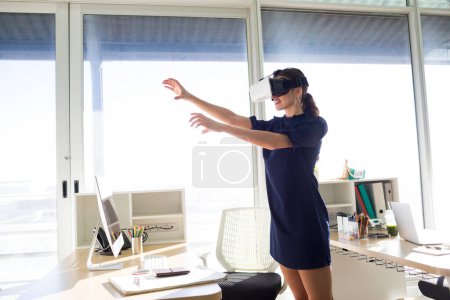 Photo for Female executive using virtual reality headset - Royalty Free Image