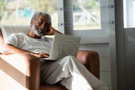 Photo for Senior man using laptop at home - Royalty Free Image