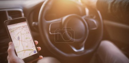 Photo for Man looking at GPS on his phone - Royalty Free Image
