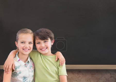 Photo for Blackboard with kids hugging - Royalty Free Image