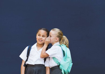 Photo for Blackboard with schoolgirls whispering - Royalty Free Image