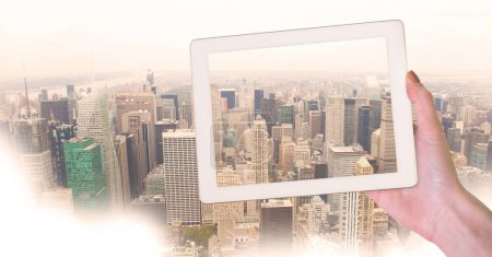Photo for Holding tablet and City view - Royalty Free Image