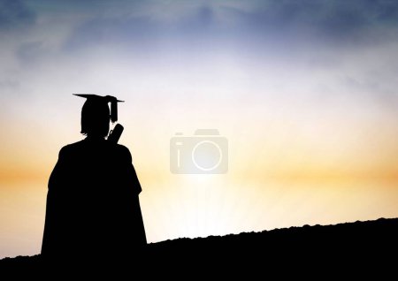 Photo for Graduate student holding his diploma against sunset or sunrise - Royalty Free Image