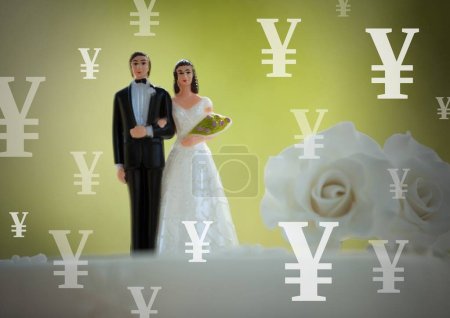 Photo for Wedding couple on cake with  Yen currency icons - Royalty Free Image