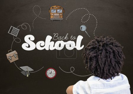 Photo for Boy and Back to school text with school graphics on blackboard - Royalty Free Image
