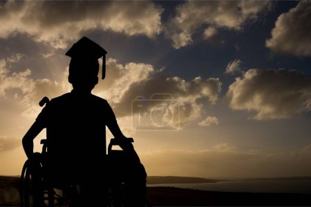 Photo for Graduate disabled student against sunset or sunrise - Royalty Free Image