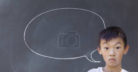 Photo for Boy with speech bubble of chalk on blackboard - Royalty Free Image