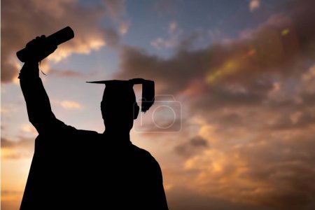 Photo for Graduate student raising the diploma against sunset or sunrise - Royalty Free Image