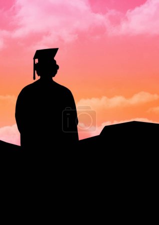 Photo for Silhouette of a student man with a backpack on the background of mountains and sunset - Royalty Free Image