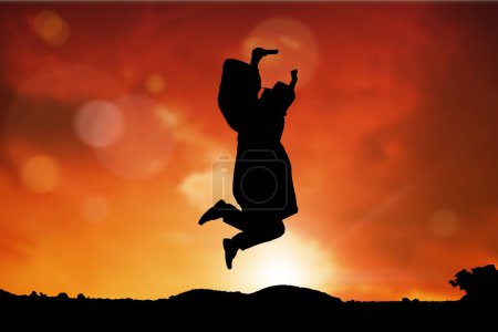 Photo for Graduate student jumping and raising the diploma against sunset or sunrise - Royalty Free Image