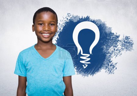 Photo for Boy standing next to light bulb - Royalty Free Image