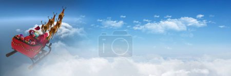 Photo for Cloudy sky transition of Santa's sleigh and reindeer's - Royalty Free Image