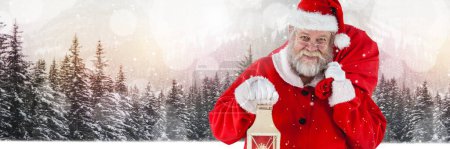 Photo for Santa with Winter landscape holding lantern and sack - Royalty Free Image