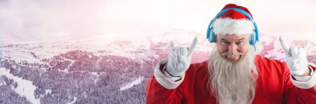Photo for Santa with Winter landscape and DJ party headphones - Royalty Free Image