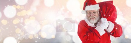Photo for Santa claus with christmas sack against blurred lights background - Royalty Free Image