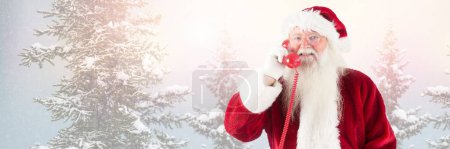 Photo for Santa Claus in Winter with red phone - Royalty Free Image