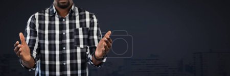 Photo for Businessman with hands palm open and dark background - Royalty Free Image