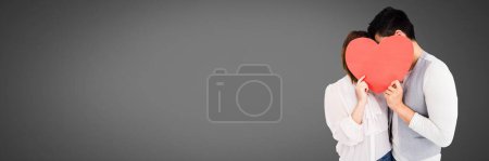 Photo for Valentines couple holding heart with grey background - Royalty Free Image