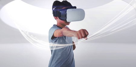 Photo for Boy using virtual reality headset while gesturing - Royalty Free Image