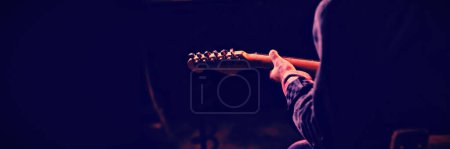 Photo for Mid-section of man playing guitar - Royalty Free Image