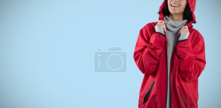 Photo for Composite image of woman in hooded jacket standing against white background - Royalty Free Image
