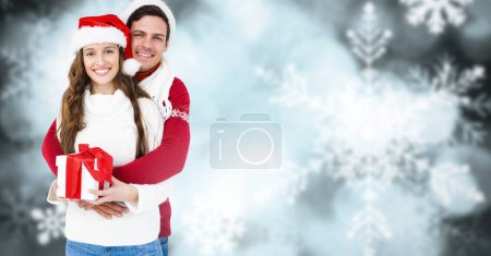 Photo for Winter couple with snowflakes and gift - Royalty Free Image