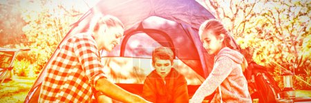 Photo for Family reading the map outside the tent - Royalty Free Image