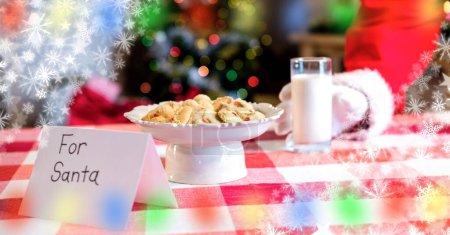 Photo for Santa eating cookies and milk at Christmas - Royalty Free Image