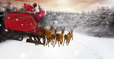 Photo for Santa flying in sleigh with reindeer over Winter forest - Royalty Free Image