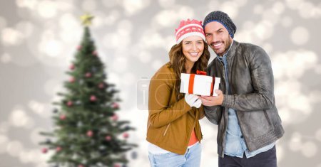 Photo for Christmas Winter couple with Christmas tree and gift - Royalty Free Image