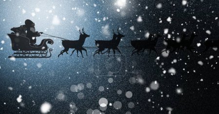 Photo for Santa flying in sleigh with reindeer through night sparkles - Royalty Free Image