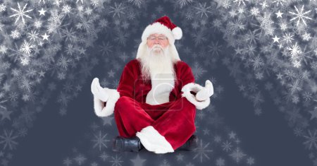 Photo for Santa meditating with snowflakes for background - Royalty Free Image