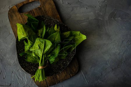 Photo for Close-up shot of fresh organic spinach on tabletop for background - Royalty Free Image