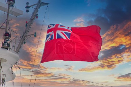 Téléchargez les photos : Drapeau de la marine britannique soufflant dans le vent au coucher du soleil - en image libre de droit
