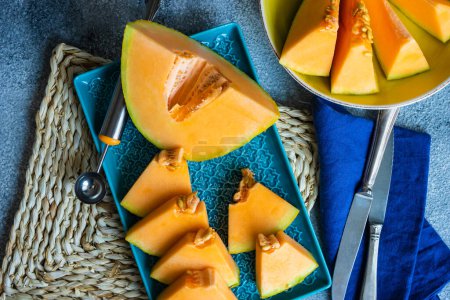 Photo for Close-up shot of fresh organic sliced melon on tabletop for background - Royalty Free Image