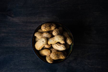 Foto de Primer plano de cacahuetes orgánicos frescos en la mesa para el fondo - Imagen libre de derechos