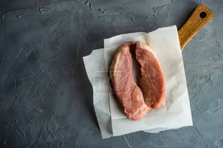 Photo for Raw pork meat in paper - Royalty Free Image