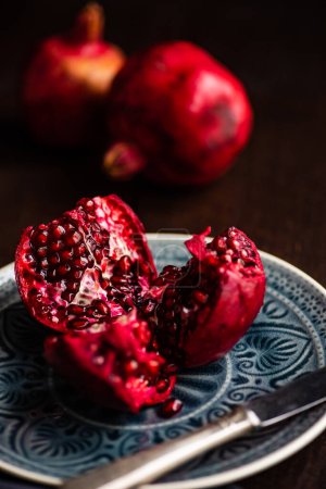 Photo for Close-up shot of fresh organic pomegranate on tabletop for background - Royalty Free Image