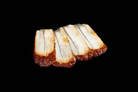 Photo for "sliced smoked eel on black background" - Royalty Free Image