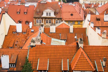 Photo for "Red roof of buildings in Prague in a cold cloudy fall weather. Old town of Prague with tiled roofs. Red roofs. Europe." - Royalty Free Image