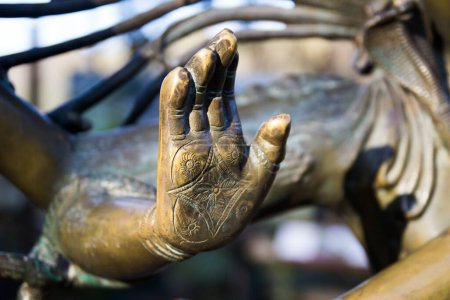 Photo for "Hand of metal statue of Buddha in Prague, Czech Republic, Europe." - Royalty Free Image