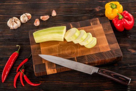 Photo for Vegetables and spices on a wooden cutting board - Royalty Free Image