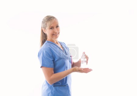 Photo for "Nurse or healthcare professional demonstrating hand sanitizer" - Royalty Free Image