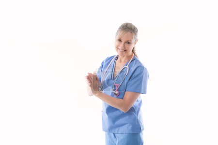 Photo for "Friendly nurse using an alcohol hand sanitizer" - Royalty Free Image