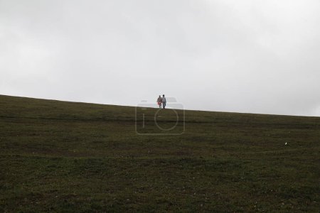 Photo for A man with a backpack walking in the mountains - Royalty Free Image